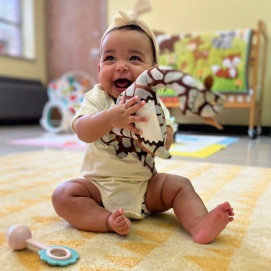 A handmade giraffe tooth pillow plushie featuring a secret saddle pocket for tiny treasures.