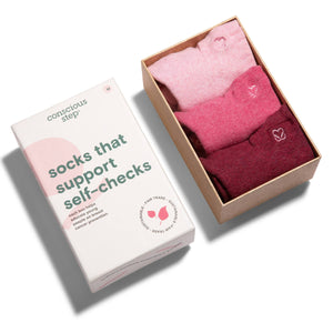 Box of pink and red socks with a 'conscious Step' packaging on a white background Box of pink and red socks with a 'conscious Step' packaging on a white background