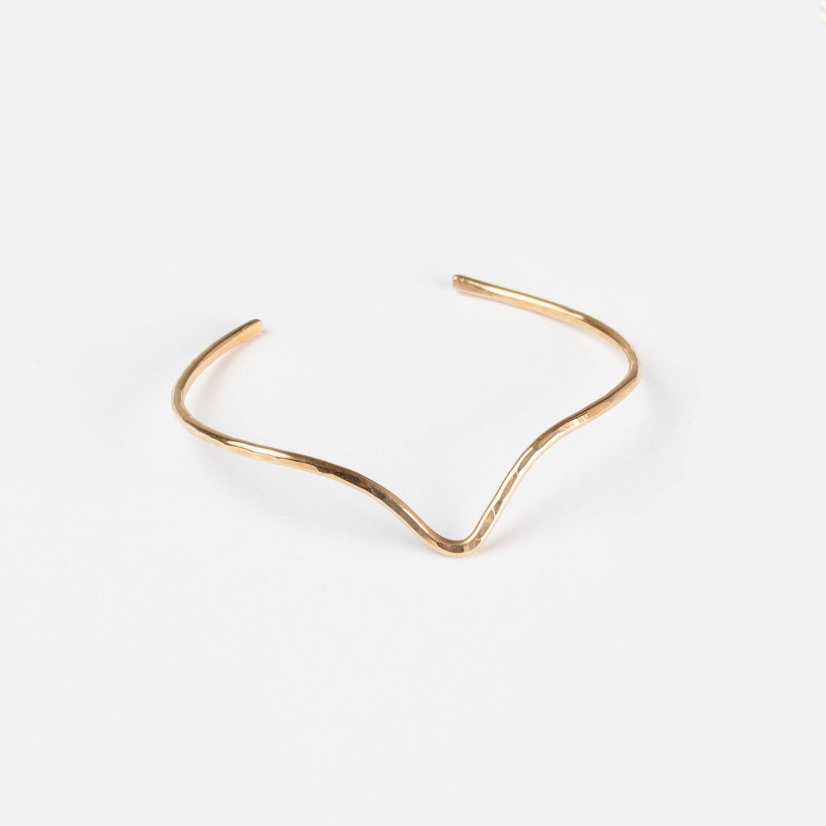 The Emily Brass Bangle on a white background, modern and classic.