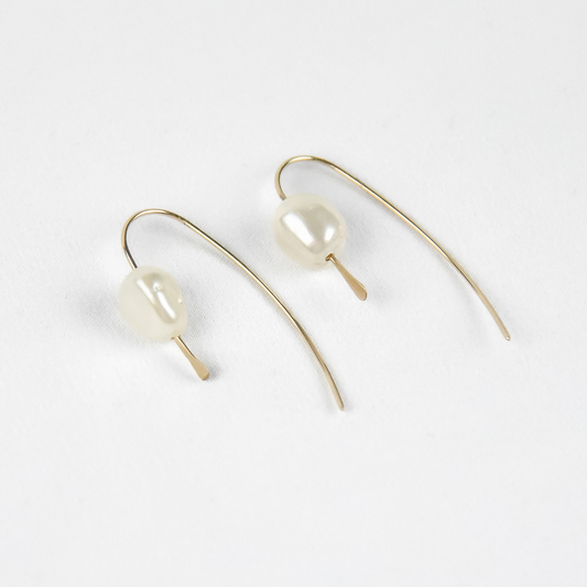 pair of 14 karat gold filled threader earrings with genuine freshwater pearls on a white background