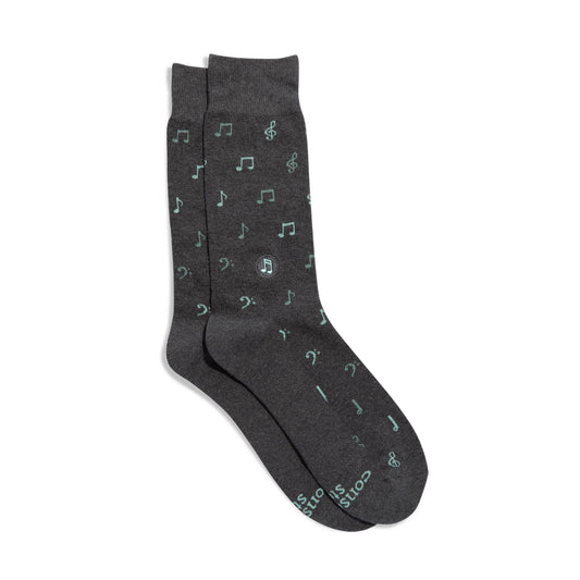 Dark gray socks with musical note pattern on a white background