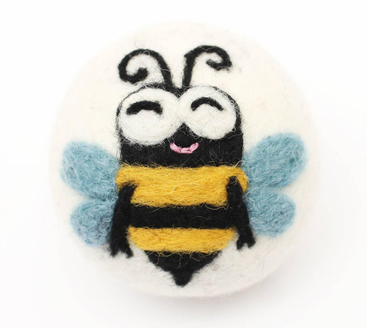 felted eco wool dryer ball with happy bee desigjn on a white background