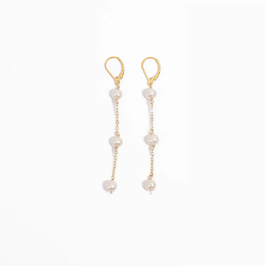 Woman wearing Leeda Freshwater Pearl Triple Drop Leverback Earrings in 14k gold Filled.