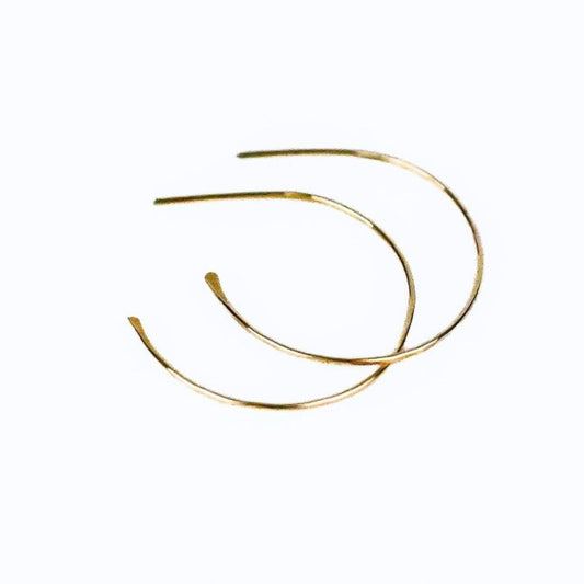 blonde model wearing simple gold hoop earrings