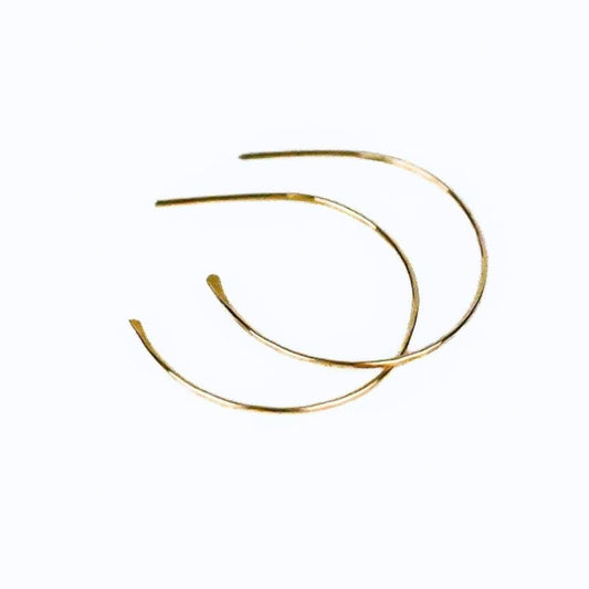 blonde model wearing simple gold hoop earrings
