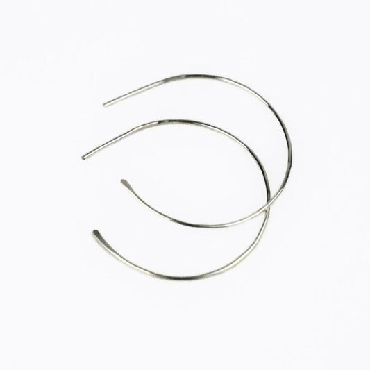 blonde model wearing simple sterling silver hoop earrings