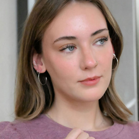 blonde model wearing simple sterling silver hoop earrings