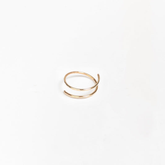 Woman wearing Hand-Hammered Wrap Ring in Brass holding a white cup