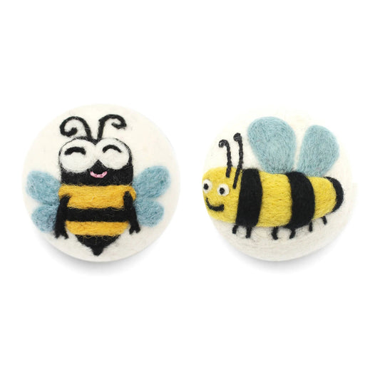 felted eco wool dryer ball with happy bee desigjn on a white background