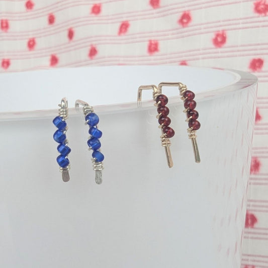 tiny gold threader earrings with four red glass seed beads