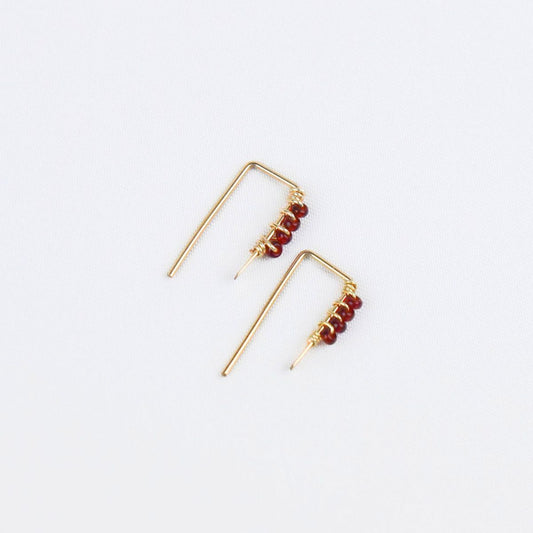 tiny gold threader earrings with four red glass seed beads