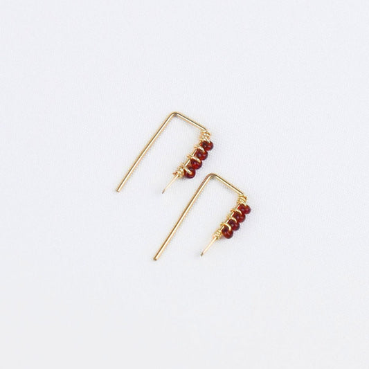 tiny gold threader earrings with four red glass seed beads