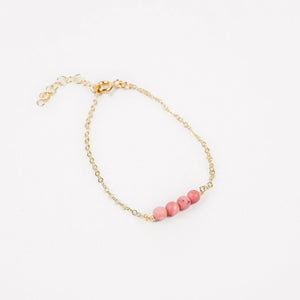 gold chain bracelet with four pink rhodonite beads in the center gold chain bracelet with four pink rhodonite beads in the center