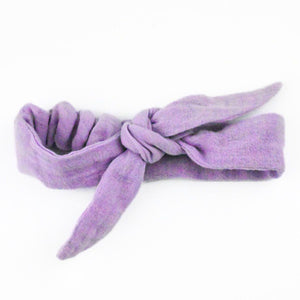 Purple knotted headband on a white background Purple knotted headband on a white background