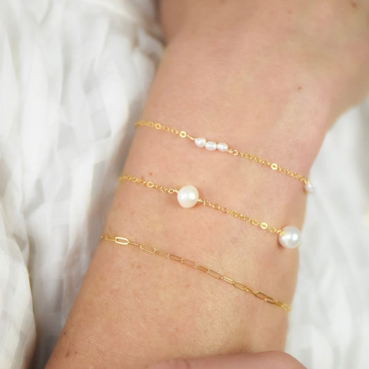 gold chain bracelet with four pearls set at separate stations