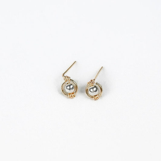 pair of gold earrings with silver bead at the center