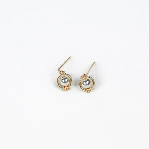 pair of gold earrings with silver bead at the center pair of gold earrings with silver bead at the center