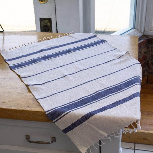 White towel with blue stripes on a light gray background