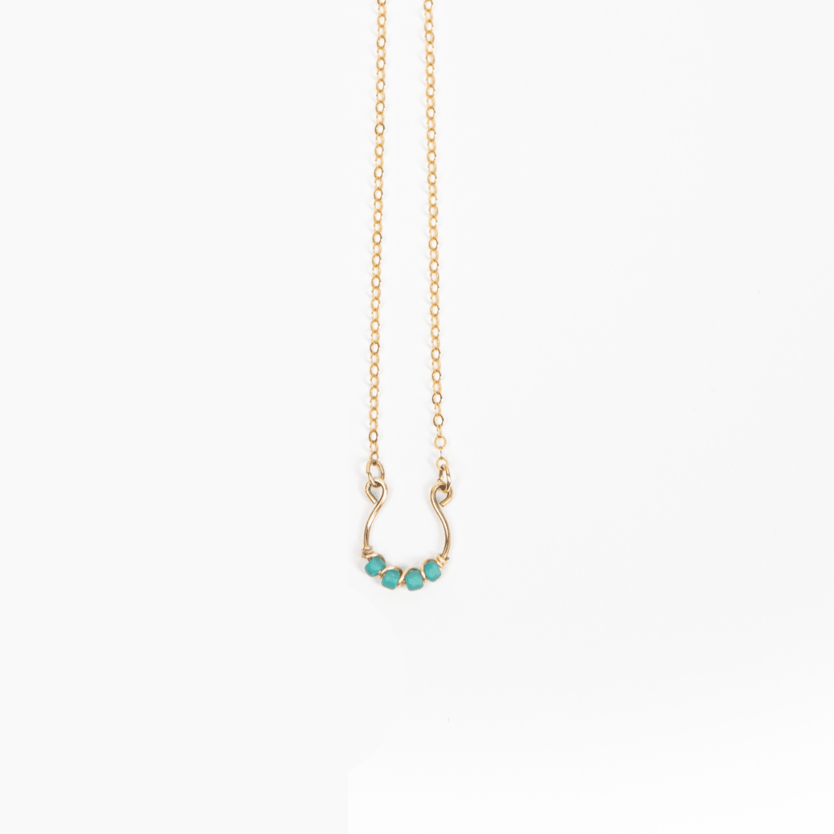Moab Western Beaded Necklace in 14k Gold Filled. Horsehoe pendant wrapped in turquoise beads.