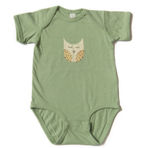 Green baby onesie with a owl design on a white background Green baby onesie with a owl design on a white background