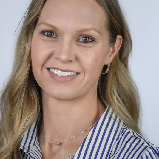 blonde woman wearing pink rhodonite beaded earrings in sterling silver