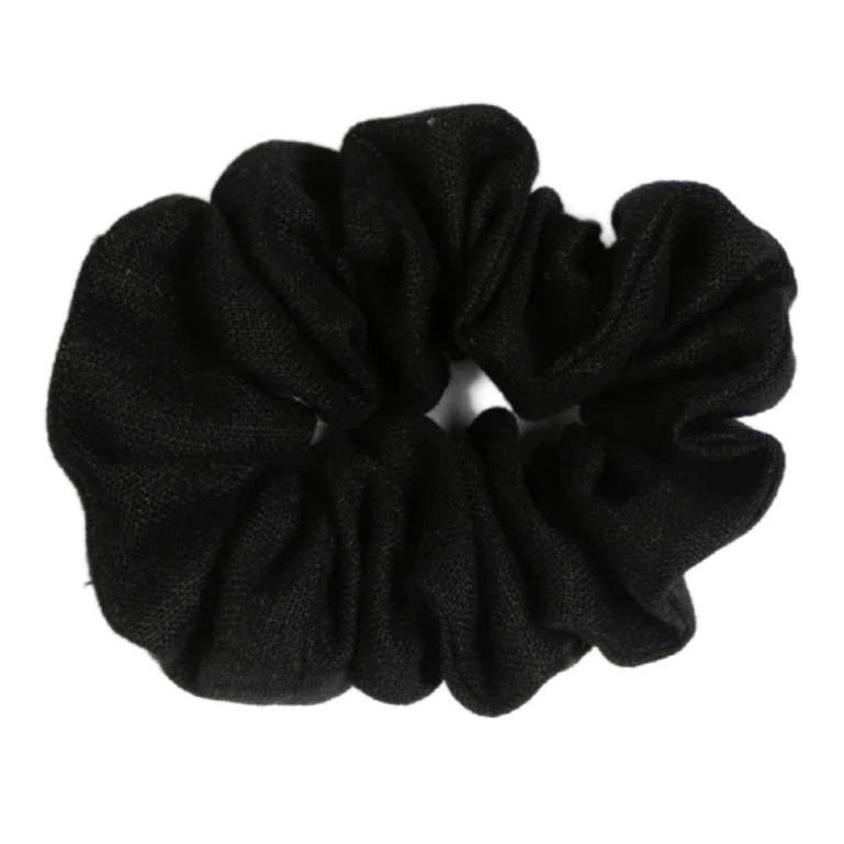 A handmade black linen scrunchie on a white background.