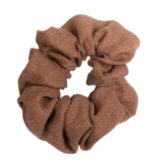 A handmade cocoa brown linen scrunchie unstretched, showing its solid color and texture.