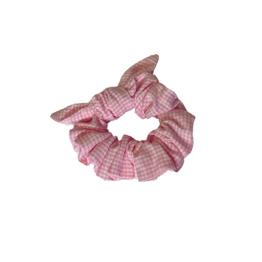Pink gingham cotton scrunchie on a white background
