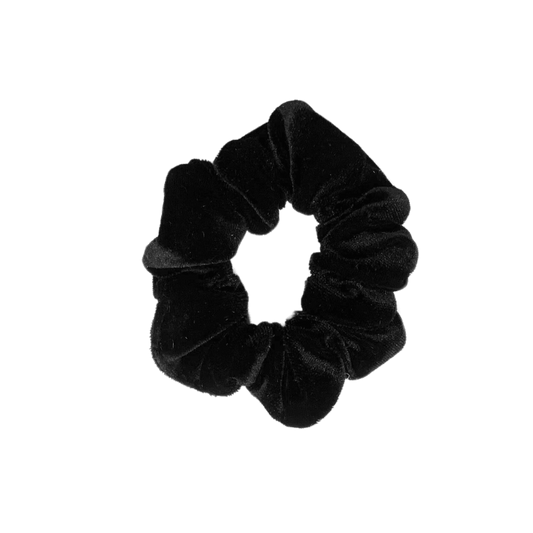 A handmade black velvet scrunchie on a white background.