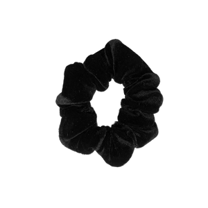A handmade black velvet scrunchie on a white background. A handmade black velvet scrunchie on a white background.