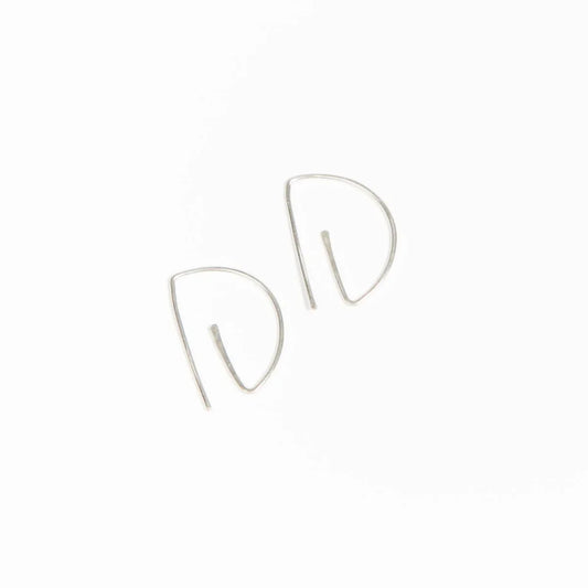 Close-up semi-sideview of woman wearing sterling silver Half Moon Threader earrings, Journey of Hope Huggie Earrings and Ear Cuff.