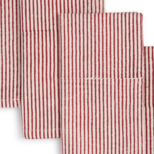Set of red and white striped cloth napkins on a white background