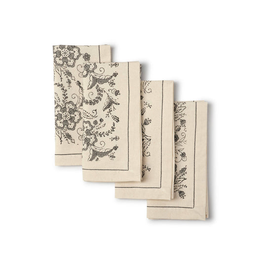 set of four beige cloth napkins with gray block printed floral pattern
