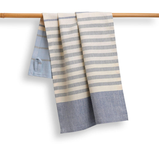 Striped towel with blue and beige pattern draped over a wooden rod on a white background