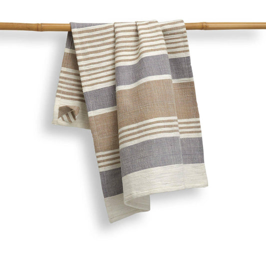 Striped towel hanging on a bamboo rod against a white background