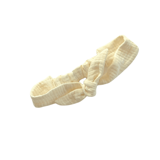 A handmade, adjustable ivory double cotton gauze tie headband for kids on white background