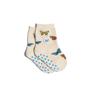 Beige socks with butterfly designs and blue polka dots on a white background Beige socks with butterfly designs and blue polka dots on a white background