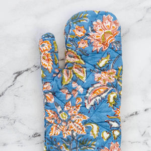 Floral-patterned oven mitt on a marble surface Floral-patterned oven mitt on a marble surface