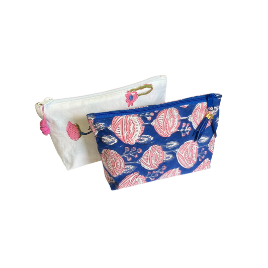 Two jaipur block print pouches, one white with pink pom-pom flowers and the other blue with pink roses.