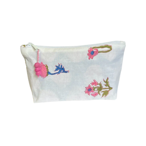White Jaipur block print zipper pouch with pink pom-pom flowers on a white background White Jaipur block print zipper pouch with pink pom-pom flowers on a white background
