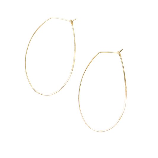 Woman in cream-colored cardigan wearing Azmera Hammered Hoop Earrings in 14k gold filled. Minimalist.