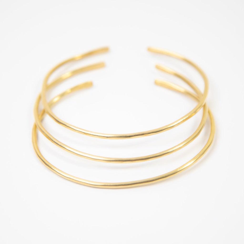 Hammered Brass Bangle, a classic, minimalist design, shown in set of three bangles