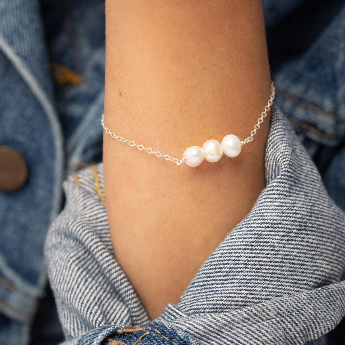Closeup of arm in denim jacket wearing the Leeda Freshwater Pearl Bracelet in Sterling Silver