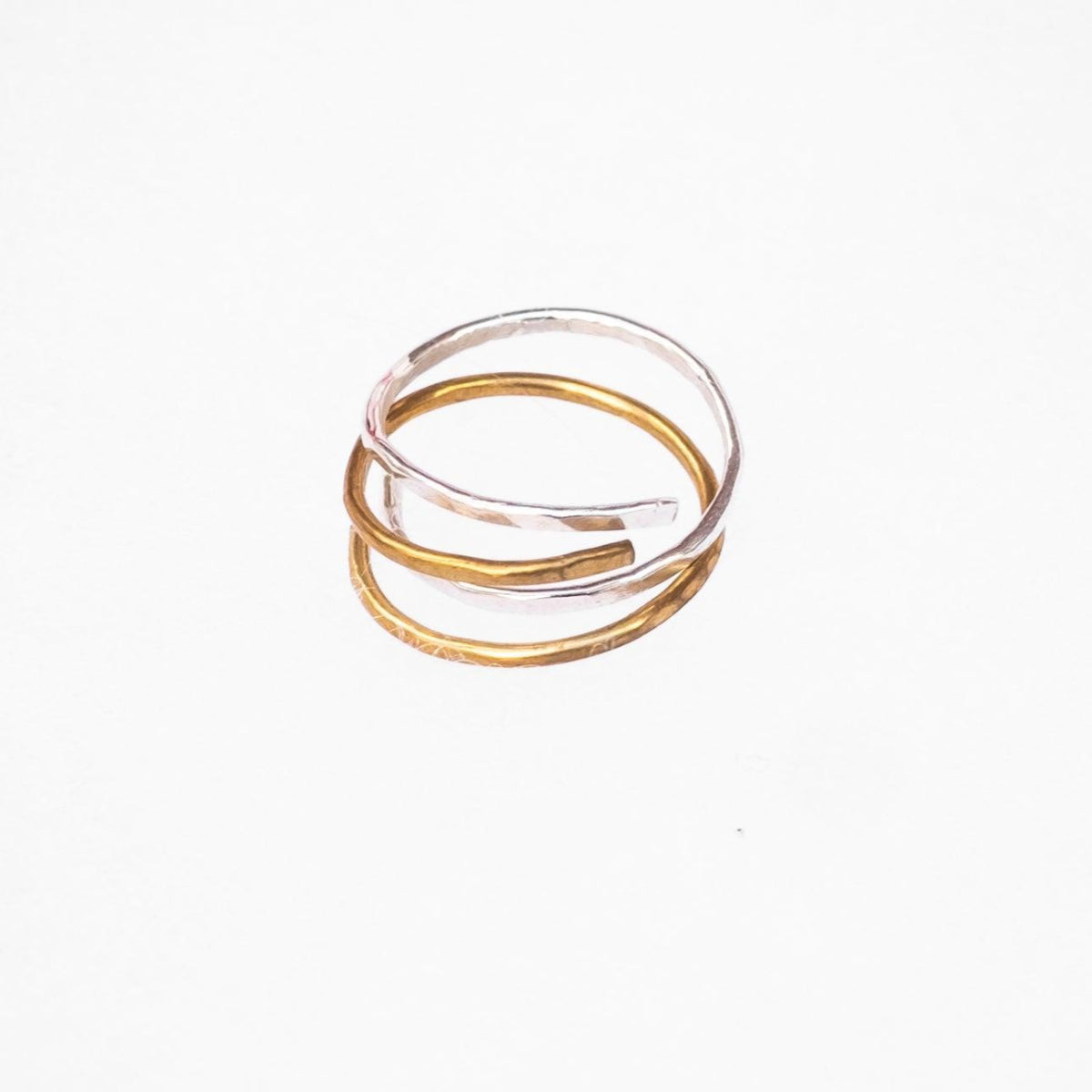 Hand-Hammered Wrap Ring in Brass stacked with sterling silver wrap ring