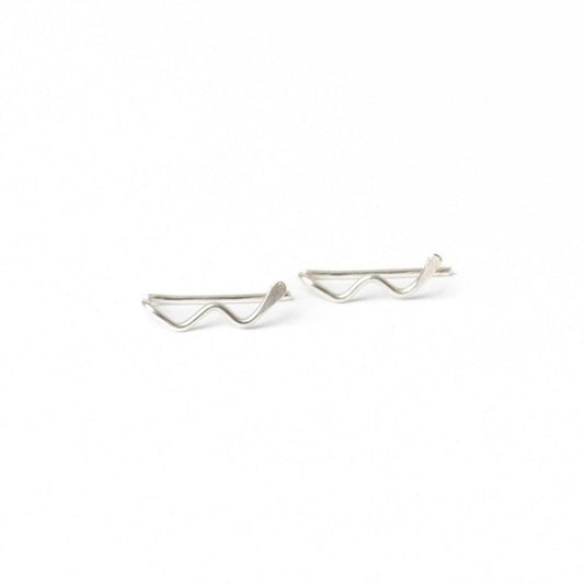 A young woman wearing Zun Zuun Threader Earrings in sterling silver. Ear climber earrings have a geometric, zig-zag design.