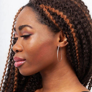 Sideview of woman wearing Azmera Hammered Hoop Earrings in Sterling Silver Sideview of woman wearing Azmera Hammered Hoop Earrings in Sterling Silver