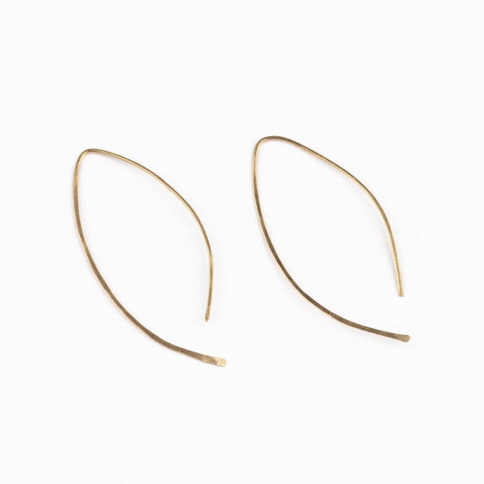A woman wearing the Qasioun Minimalist Threader Earrings in 14k gold filled, with the earrings visible as they drop from her ear lobe.