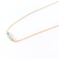 A 14k gold filled chain necklace with four amazonite gemstone spheres on it, displayed on a white background.
