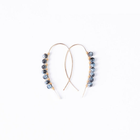A smiling woman wearing the Mai Blue Beaded Threader Earrings in 14k Gold Filled.