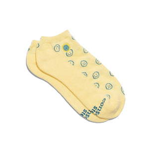 Yellow socks with smiley face patterns on a white background